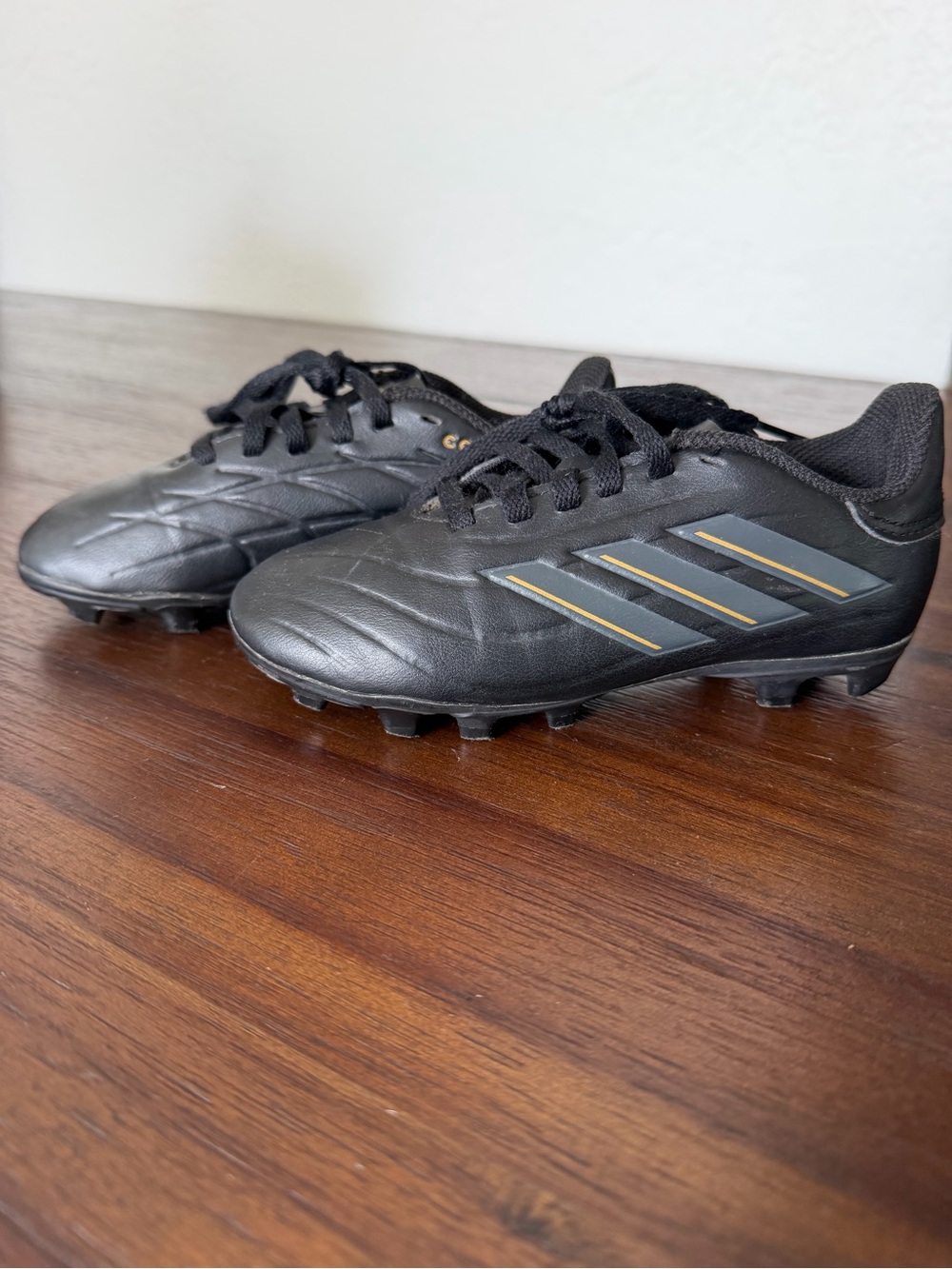 adidas Kids Black Soccer Cleats with Gray Stripes and Gold Trim
